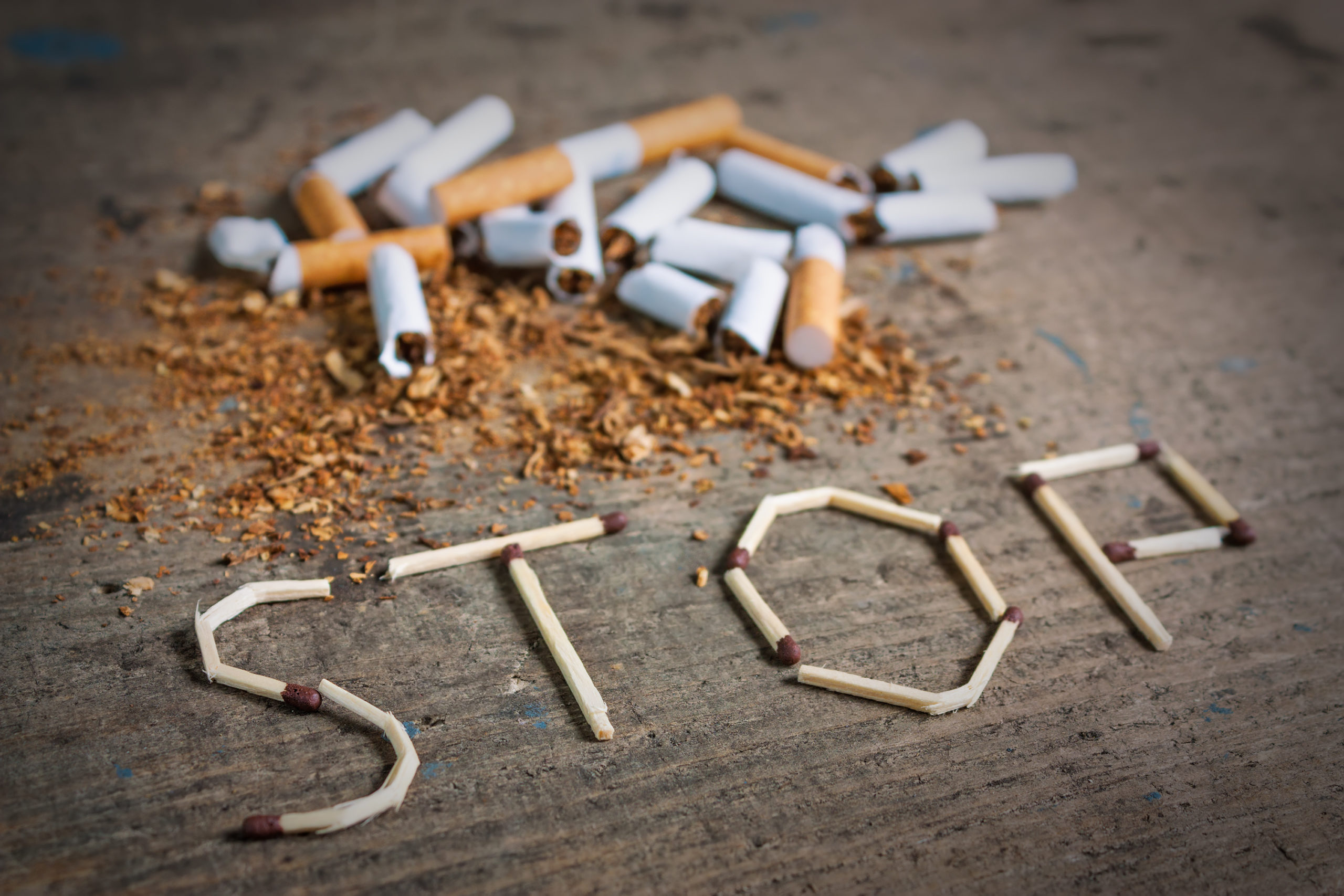Broken cigarettes and tobacco. Quit smoking now